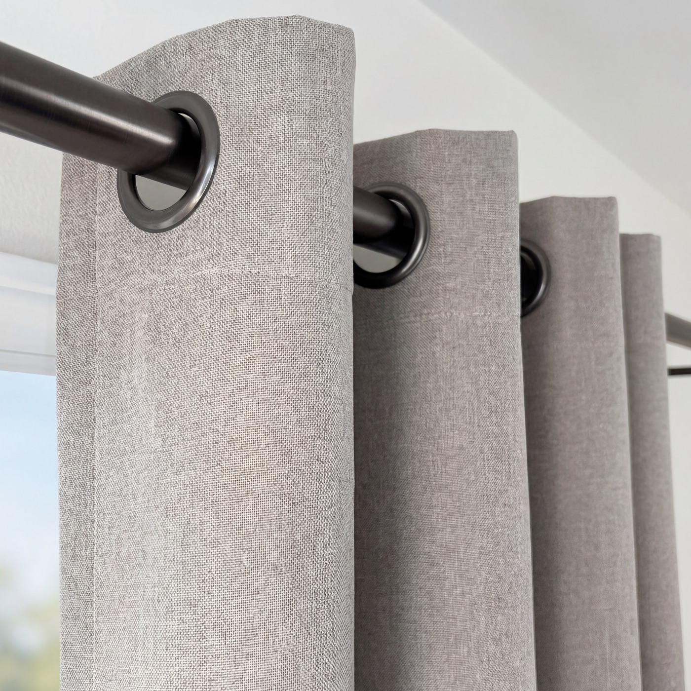 Close-up of the matte grommet top on a linen-look curtain panel